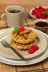 Waffles with raspberries and cinnamon. Selective focus.