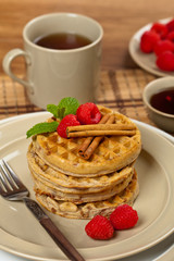 Waffles with raspberries and cinnamon. Selective focus.