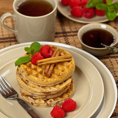 Waffles with raspberries and cinnamon. Selective focus.