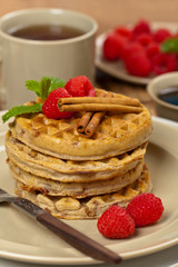 Waffles with raspberries and cinnamon. Selective focus.
