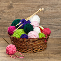 Fototapeta na wymiar Colorful yarn balls in wicker basket. Selective focus.