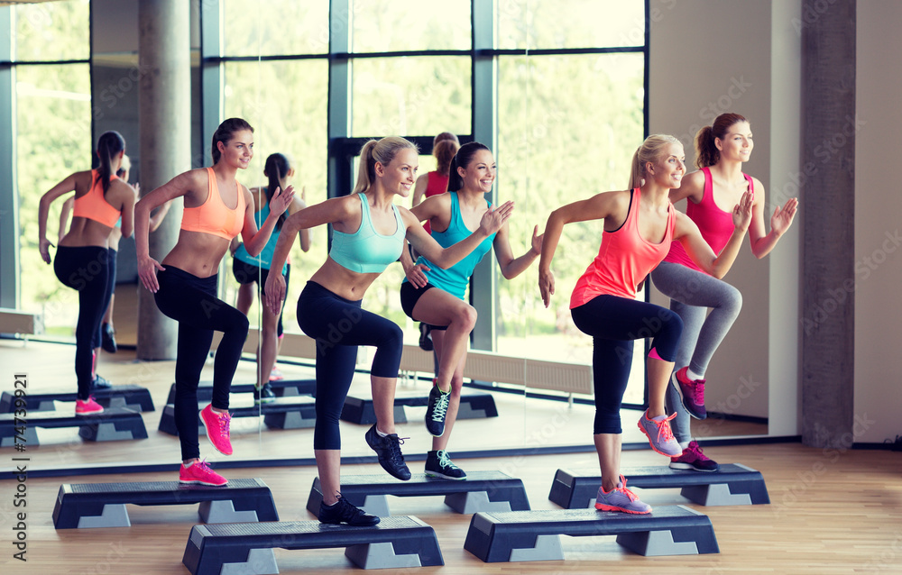 Sticker group of women working out with steppers in gym