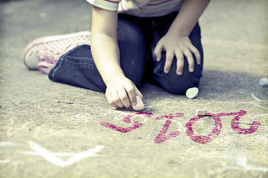 Photo of girl writing with chalk 2015 schoolyard