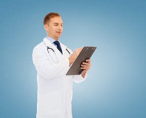 Naklejka na ściany i meble smiling male doctor with clipboard and stethoscope