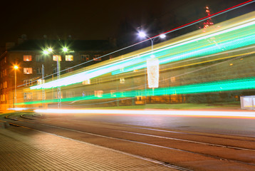 Fototapeta na wymiar Evening traffic. The city lights. Abstract background. Tram