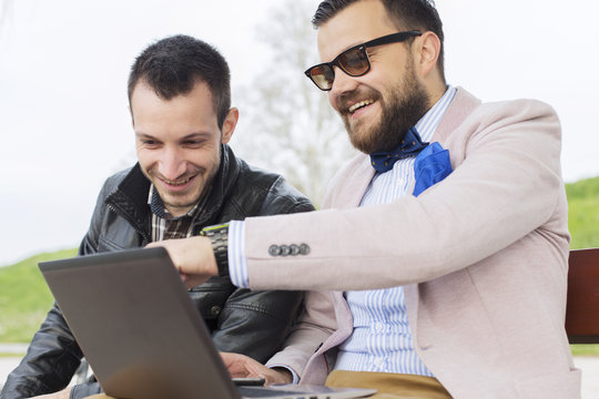 Two guys looking at laptop