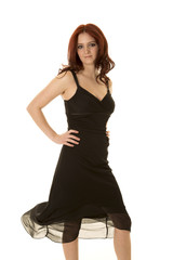 woman red hair and black dress blow look serious