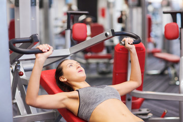 young woman exercising on gym machine