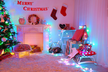 Beautiful Christmas interior with sofa, decorative fireplace