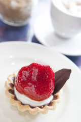 Strawberry tart on white plate