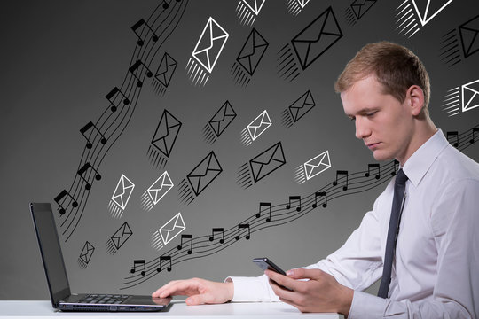 Businessman using laptop and smartphone - Powered by Adobe