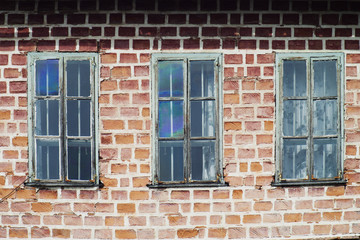 Three windows in a train yard at chama