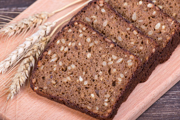 Fresh bread and wheat on the wooden