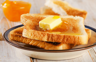 Fototapeta na wymiar Slices toast bread fresh orange jam on a wooden background .