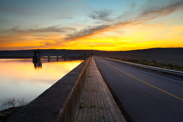 The road in dam and colorful sunset