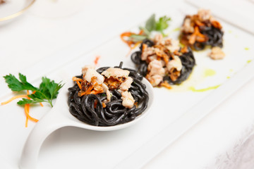 Black pasta with seafood, close-up