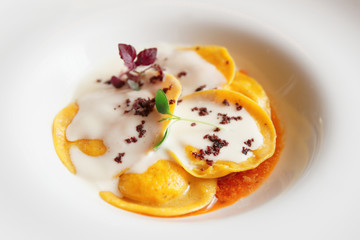 Ravioli with polenta in plate