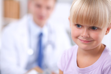 Fototapeta premium Female doctor examining child with stethoscope at surgery