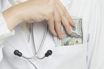 Woman doctor has put the money in a breast pocket