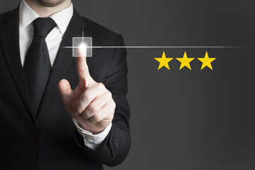 businessman pushing button rating three stars