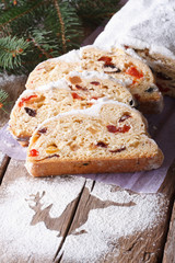 Christmas fruit cake Stollen close-up on the table. Vertical