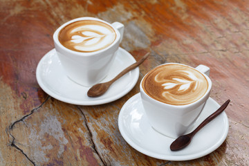 Cup of latte coffee on wooden table
