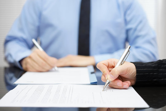 Man and woman   signing a business contract after the conclusion