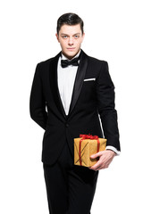 New year's eve fashion man wearing black dinner jacket. Holding