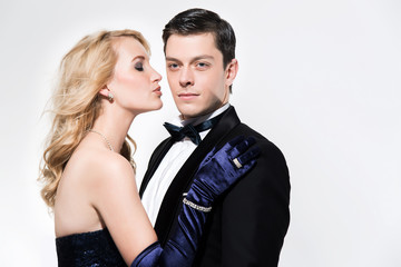 Romantic new year's eve fashion couple. Woman kissing man. Weari