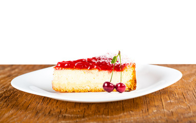 cheesecake on a white plate with cherries