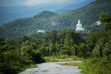 Fototapeta na wymiar White buddha on the hill