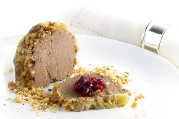 poultry liver pate in walnut coat with cranberry jam on a plate