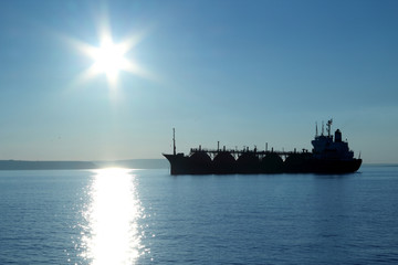 silhouette of a tanker in the night sky - 74764722