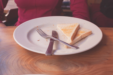Woman leaving toast on her plate