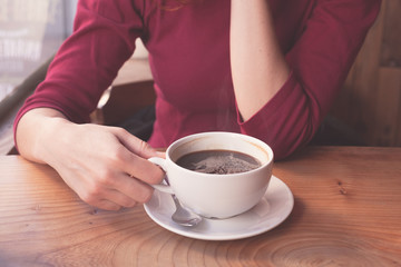 Woman having coffee in cafe