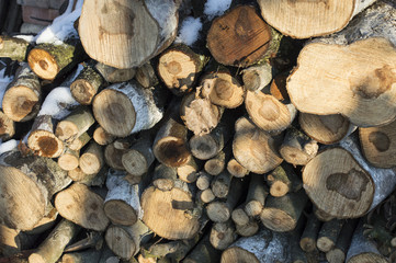 Texture-firewood cut into ridges covered with white snow