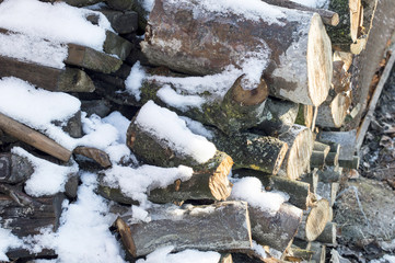 firewood cut into ridges covered with white snow