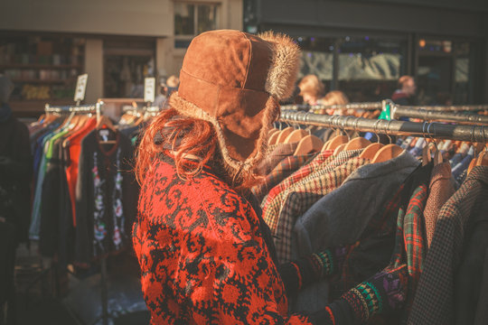 Woman browsing jackets at market