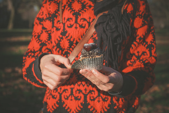 Woman in park with cupcake