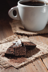 cup coffee with chocolat on wooden table and black background
