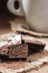 cup coffee with chocolat on wooden table and black background