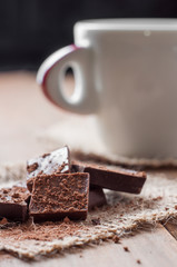 cup coffee with chocolat on wooden table and black background