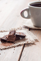 cup coffee with chocolat on wooden table and black background