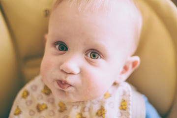 Happy Curious Young Baby Boy Eating Porridge