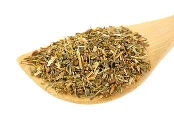 Wood spoon filled with St. Johns Wort herb