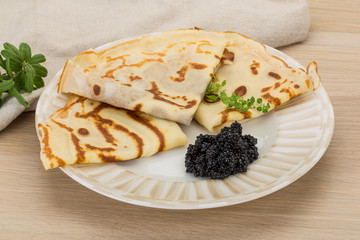 Pancakes with black caviar