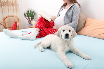 Pregnant woman with her dog at home