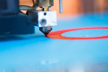 head of 3d printer in action, macro view