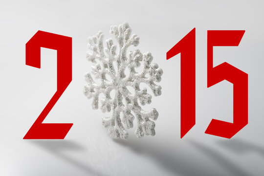 New year 2015 sign with snowflake toy on white background