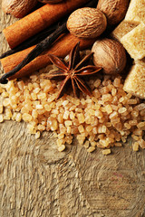 Christmas spices and baking ingredients on wooden background